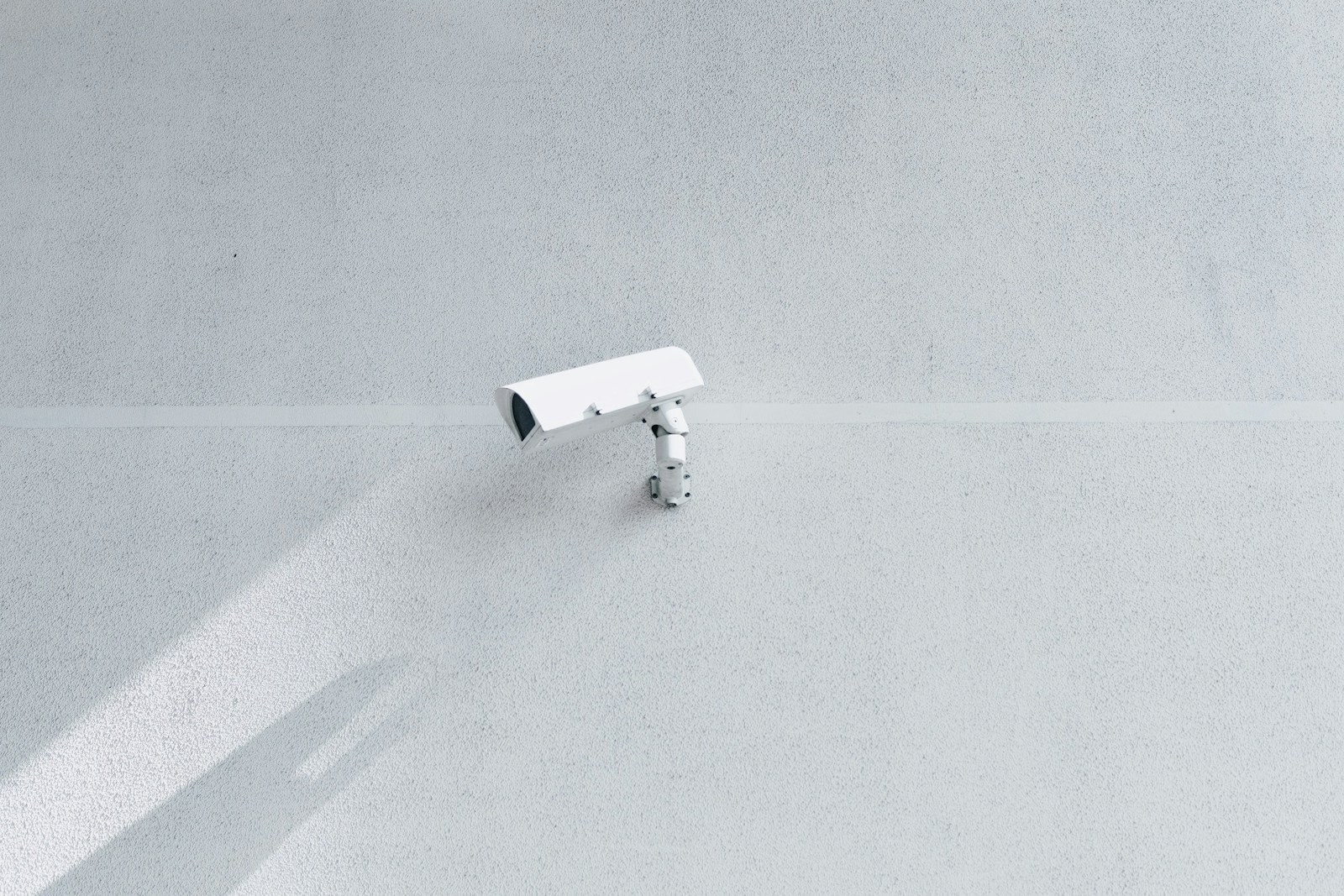 Security camera mounted on a clean white wall